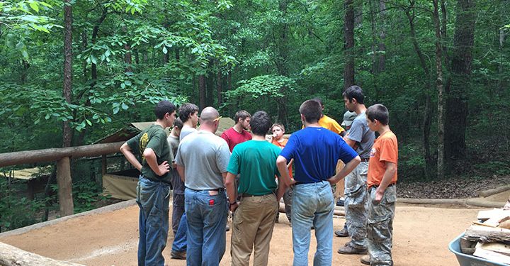 boys circling up at camp to resolve problems