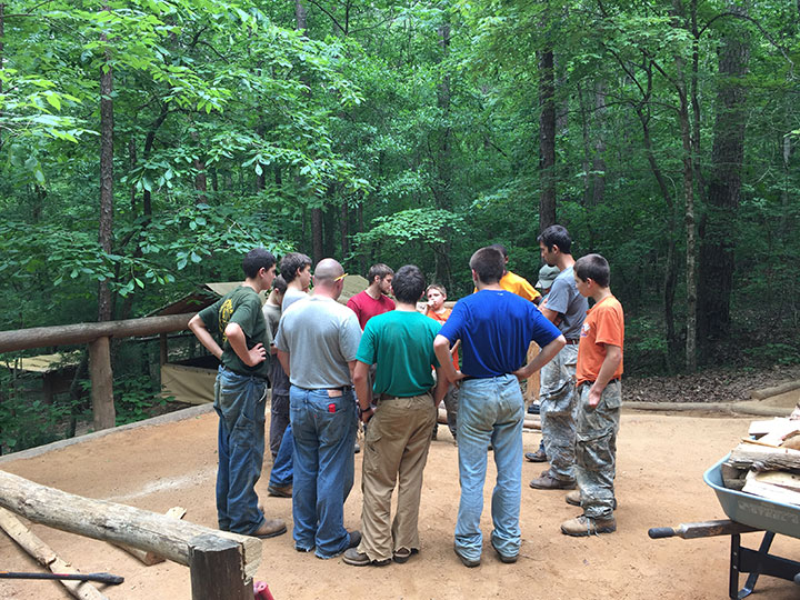 boys circling up at camp to resolve problems