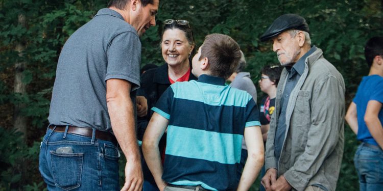 Family worker Josh encourages a family during families day