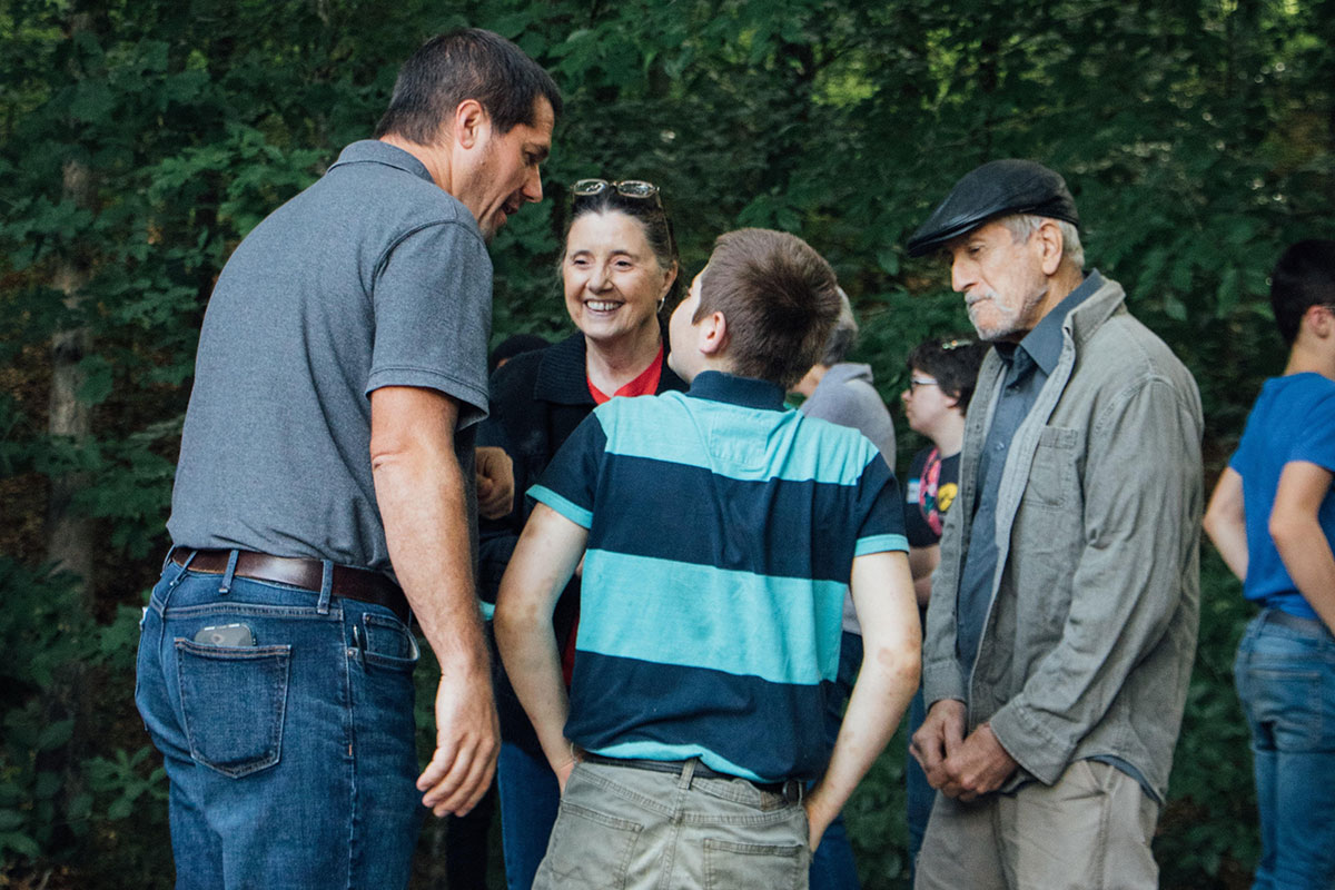 Family worker Josh encourages a family during families day