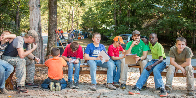 Guy at boys camp with fellow campers