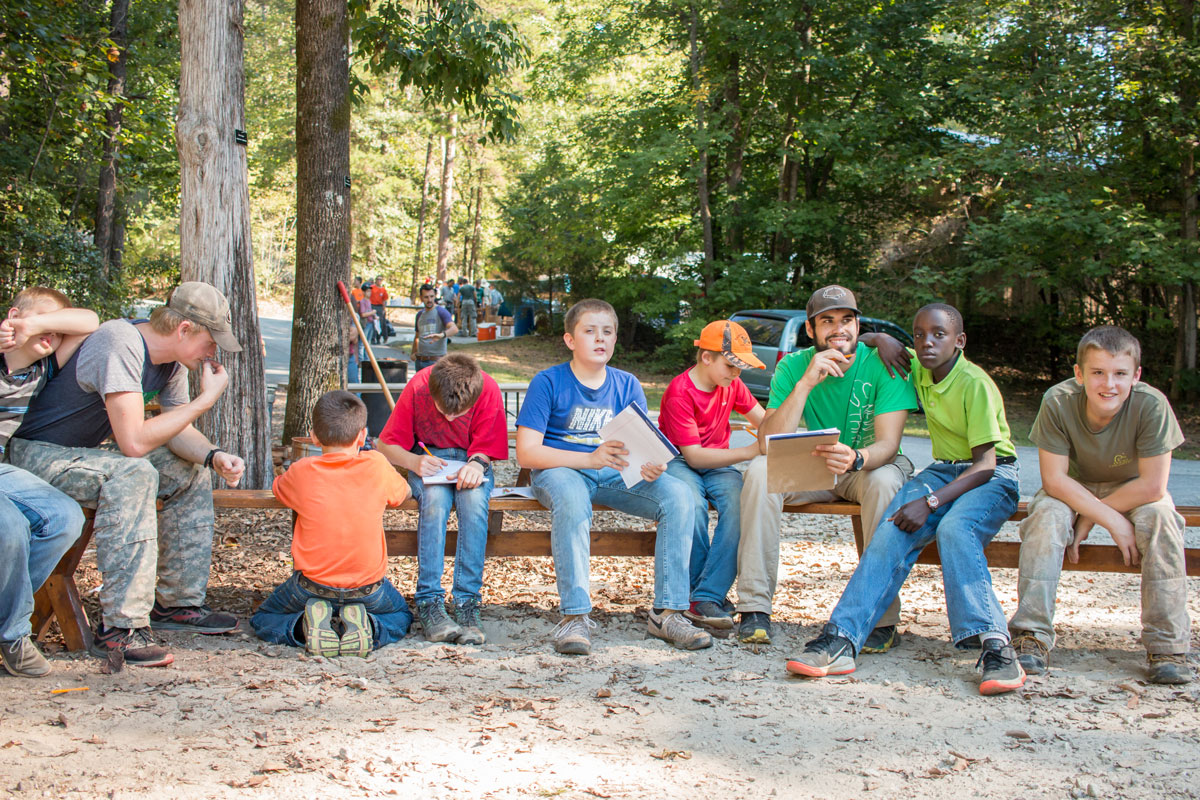 Guy at boys camp with fellow campers